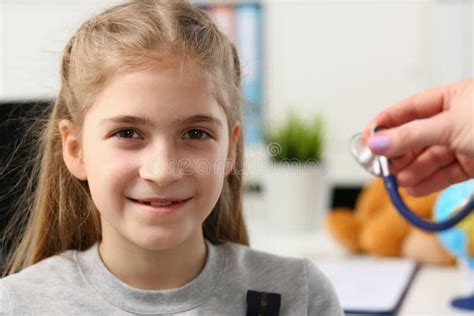 Portrait Of A Beautiful Child Girl And Doctor Hand With Stethoscope