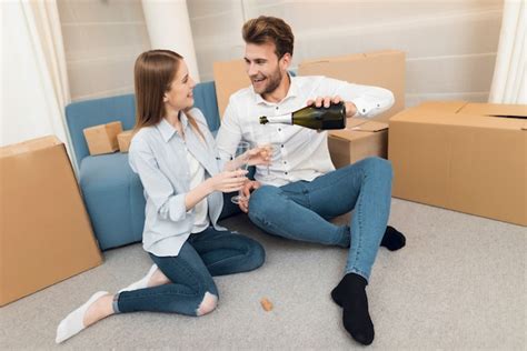 Premium Photo Young Couple Celebrates Buying A New Home