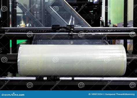 Roll Of Plastic Packaging Film On The Automatic Packing Machine In Food