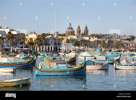 Traditional Colorful Fishing Boats Luzzu Moored At Marsaxlokk