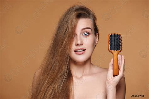 Beautiful Smiling Brunette Woman Showing Wooden Brush Stock Photo
