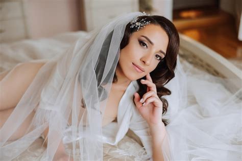 Premium Photo A Beautiful Brunette Bride With A Tiara In Her Hair Is Preparing For The Wedding