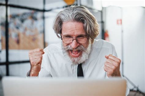 Expressive Mature Businessman With Grey Hair And Beard In Formal