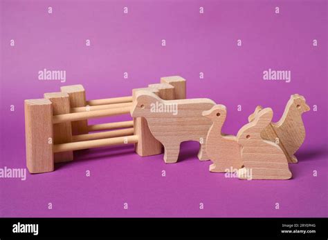 Wooden Animals And Fence On Purple Background Childrens Toy Stock