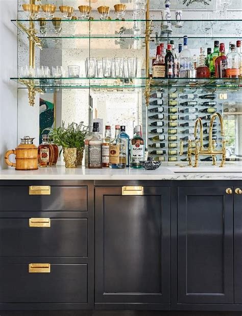 Black Wet Bar Cabinets Accented With Polished Brass Modern Hardware Are Topped With A White And