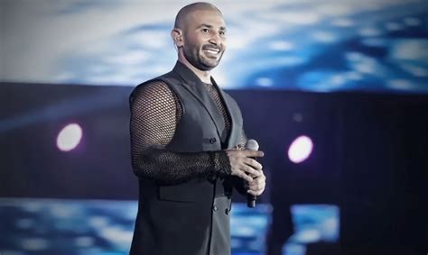 Earrings and a transparent shirt. The appearance of the singer Ahmed ...