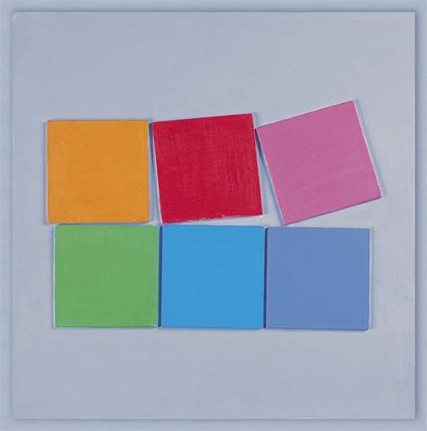 Four Square Pieces Of Colored Paper Sitting On Top Of Each Other In