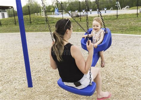 Cute Baby Girl Playing on Outdoor Playground with Mother on Swing Stock ...