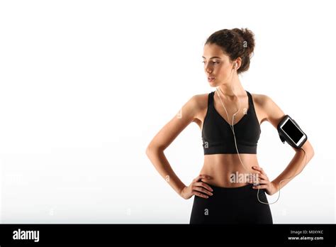 Pretty Curly Brunette Fitness Woman Holding Arms On Hips And Listening