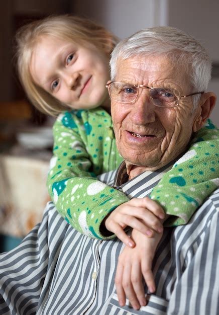 Premium Photo Portrait Of Smiling Senior Man And The Great Granddaughter