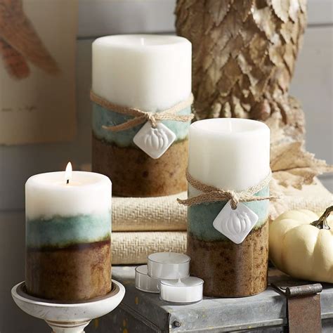 Three Candles Sitting Next To Each Other On Top Of A Table With