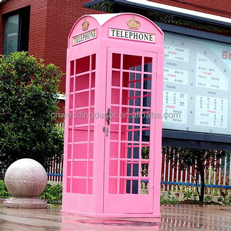 A Pink Phone Booth Sitting In Front Of A Building