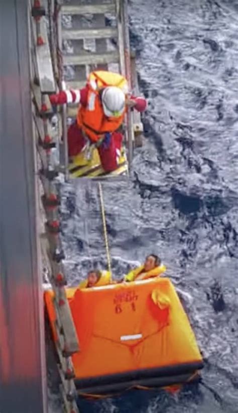 Incredible moment two exhausted sailors are plucked from the raging ...