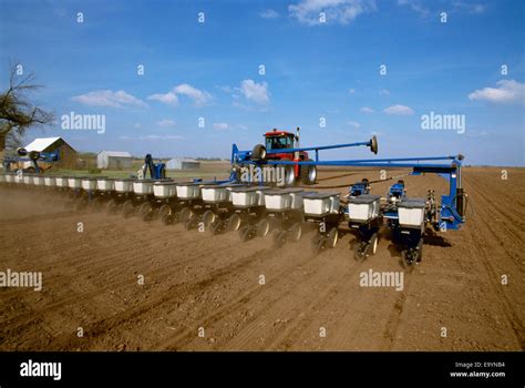 A Case Ih Tractor Pulling A 24 Row Kinze Planter And Planting Grain