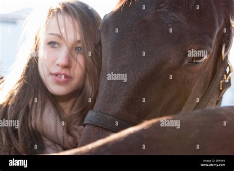 Close Up Of Young Woman With Horses Stock Photo Alamy