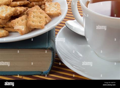 Detail Of A Cup Of Tea And A Plate Of Crackers Close Up With Vintage