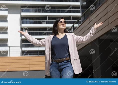 Happy Mature Woman With Open Gesture Arms Enjoys Modern Residential