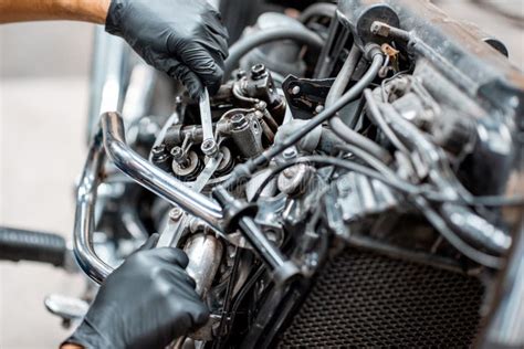 Worker Repairing Motorcycle Engine At The Workshop Stock Photo Image