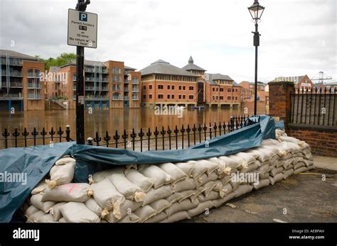 Sandbag Wall At The Side Of The River Ouse A Temporary Flood Barrier