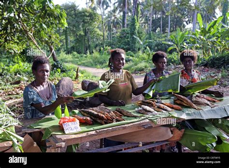 Women Wave Flies Of The Fishes Market Stall On The Road To Arawa