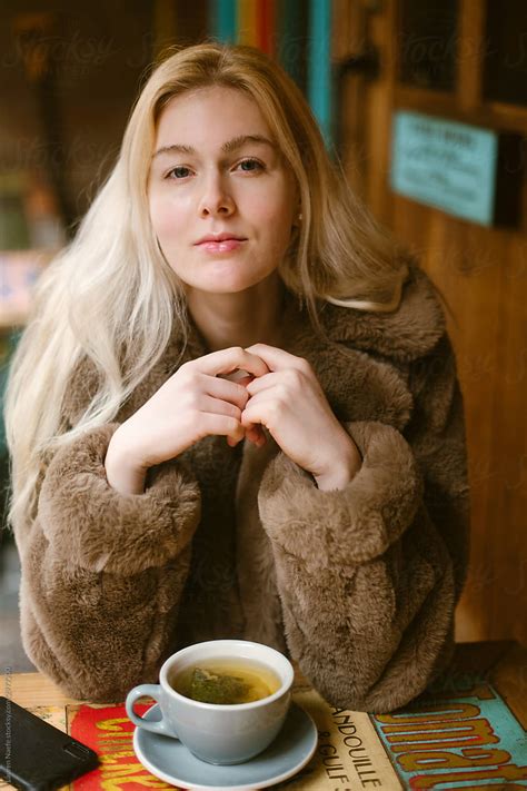 Woman Smiling At Camera Over Cup Of Tea By Stocksy Contributor