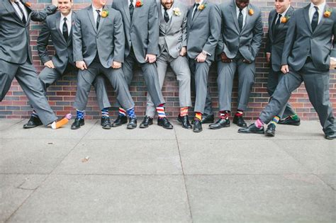 Groomsmen In Bright Mismatched Socks And Gray Suits