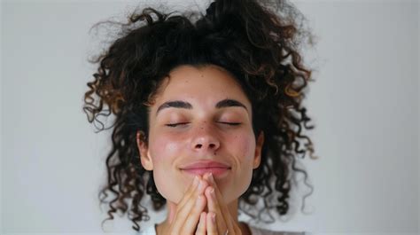 Thoughtful Young Woman With Curly Hair And Freckles On Her Face She Has Her Eyes Closed And Her