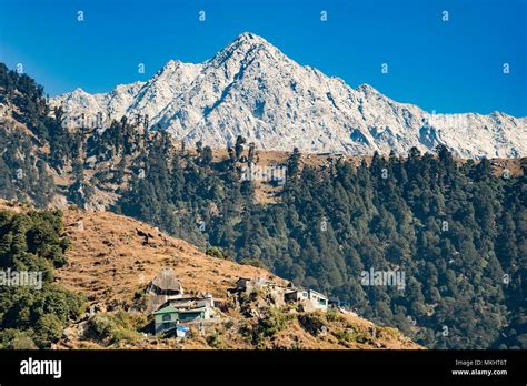 A distant view of Dhauladhar Mountain ranges during a sunny day. Triund ...