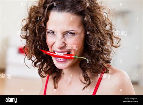 Woman Biting Red Chili Pepper Hi Res Stock Photography And Images Alamy