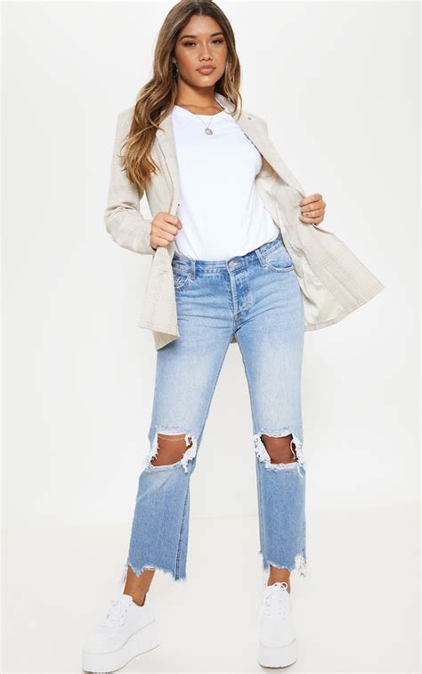 Mid Wash Low Rise Distressed Knee Rip Jeans Prettylittlething