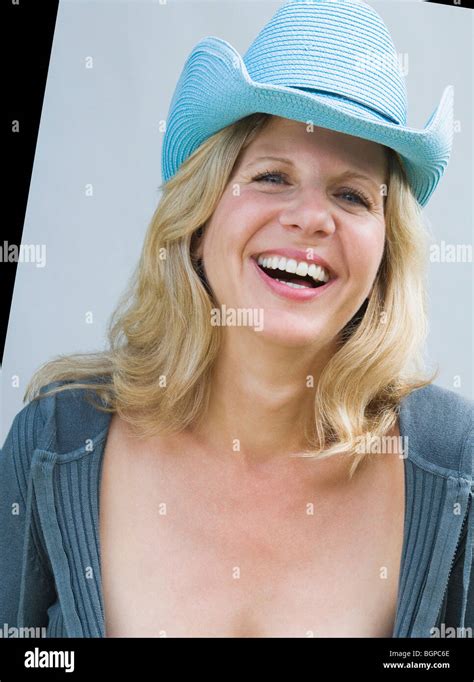 Portrait Of A Mature Woman Wearing A Cowboy Hat And Smiling Stock Photo Alamy
