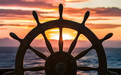 Ship Steering Wheel Helm At Sunset Maritime Navigation Concept