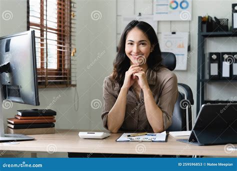 Asian Woman Accountant Preparing Annual Financial Report Checking