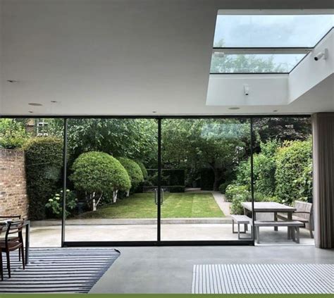 An Open Living Room With Sliding Glass Doors