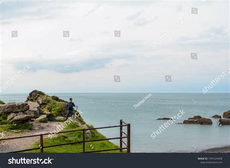 Man Standing Cliff Edge Looking View Stock Photo 1991324408 | Shutterstock