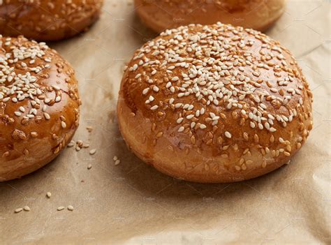 Baked Sesame Buns On Brown Parchment Containing Bun Sesame And Bread