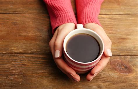 Premium Photo Female Hands Holding Cup Of Coffee On Wooden Background