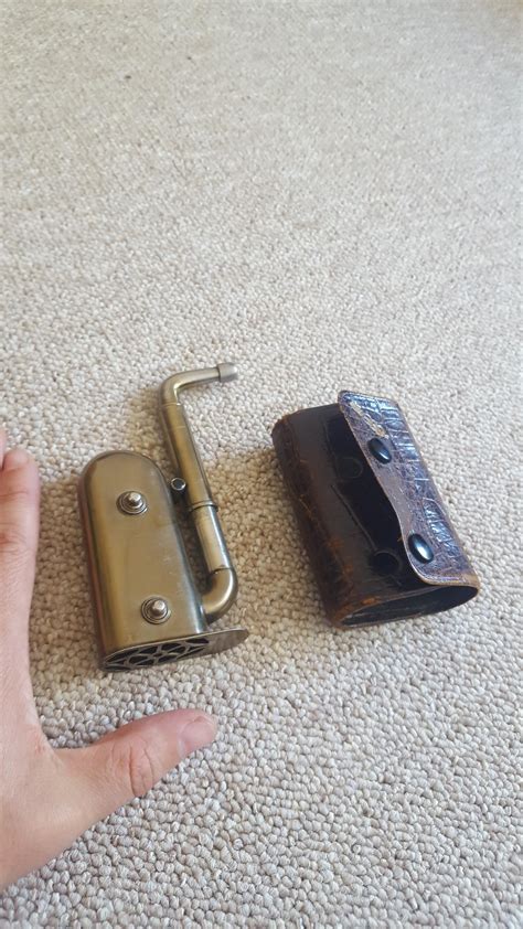 Metal thing and it's leather case. Found when clearing my grandad's