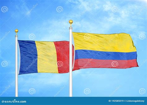 Romania And Colombia Two Flags On Flagpoles And Blue Sky Stock Image