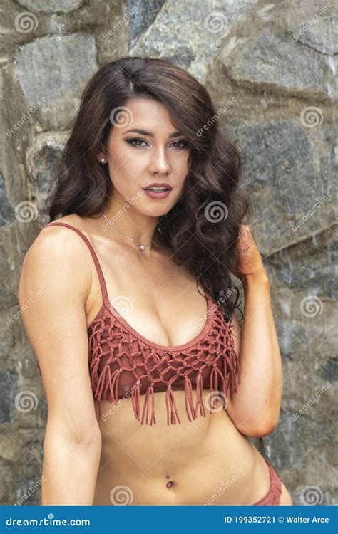 A Lovely Brunette Swimsuit Model Enjoys Her Holiday At The Pool In The Caribbean Stock Image
