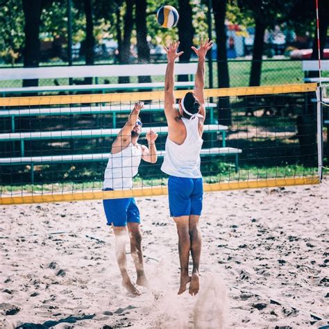 Premium Photo | Beach volleyball players on the net