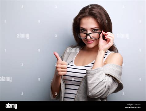 Happy Smiling Casual Woman In Glasses Showing Thumb Up On Blue