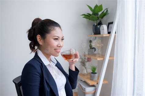 Beautiful Mature Woman Drinking A Cup Of Tea In Her Office Wit Stock Photo Image Of Portrait