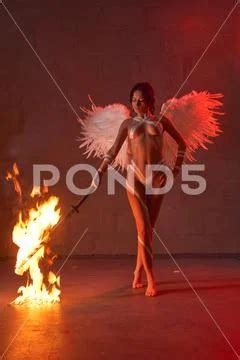 Graceful Nude Woman In Wings With Flaming Sword Stock Photo 231384625