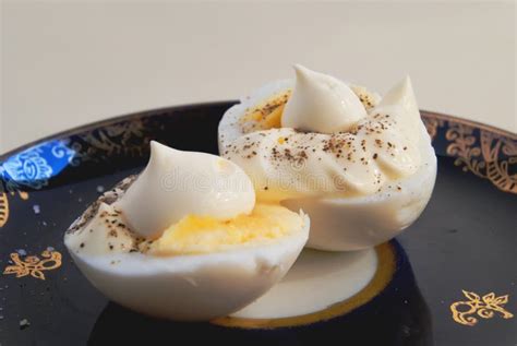 Two Halves Of Boiled Egg With Sauce And Pepper Stock Image Image Of