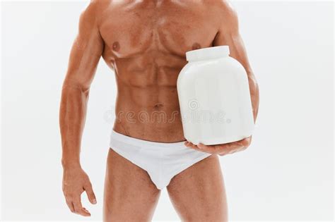 Man Bodybuilder Boxer With Naked Torso With Abs Holding A Can Of Muscle