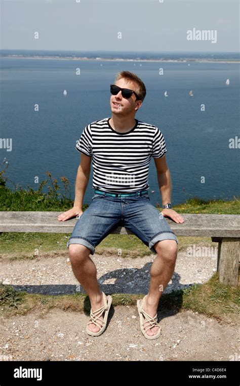 Man Wearing Striped T Shirt On Holiday Wearing Sunglasses Relaxing And