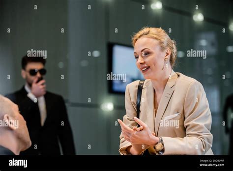 Polite Businesswoman Talking To Receptionist In Hotel Hospitality Industry Blonde And Cheerful