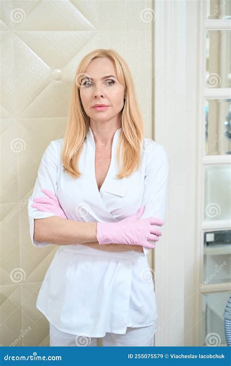 Woman Beautician In Pink Medical Gloves Stands In Beauty Room Stock