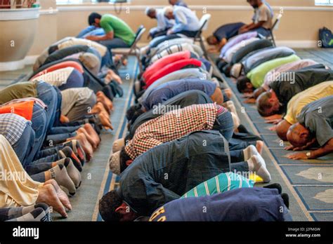 Muslim Men Prostrate Themselves In Sujood Prayer Position With Their